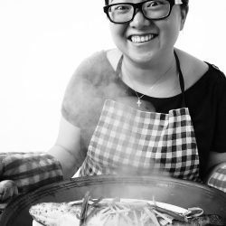 A photo by Marie Yip, titled, "Joy of Serving a Steamed Fish"