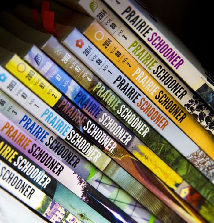 The spines of a dozen or so issues of Prairie Schooner journal.