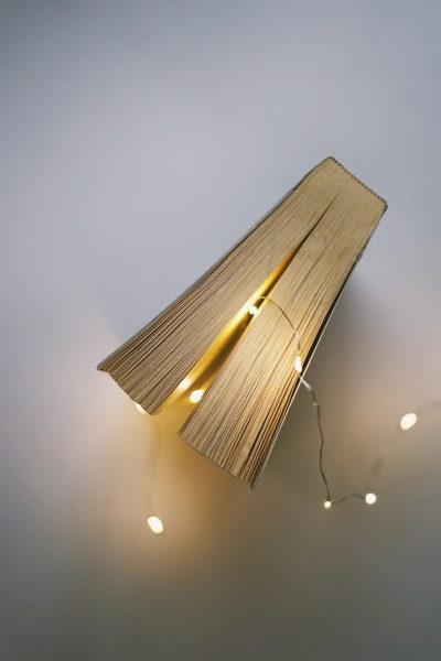 A book with a string of lights coming out of it.